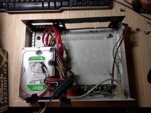 The sad fate project box in the middle of the operation. I had to drill yet another hole to have the new NIC fixed.